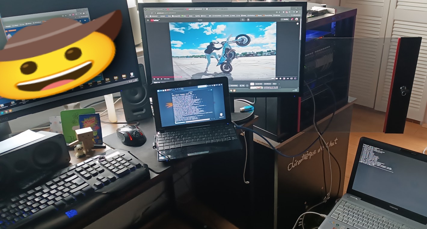 Author's current home laboratory workstation with a Linux desktop, multiple displays, laptops and surrounding equipment